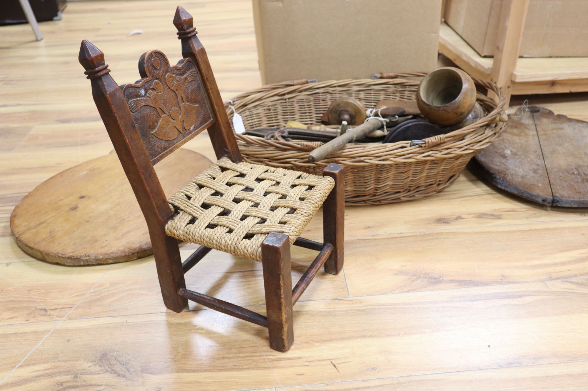 A large quantity of 19th/20th century treen, including an elm candlebox, bread boards, a child's chair, spoons etc.